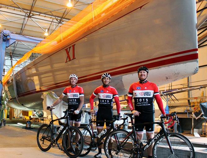 Three of the Wild Oats XI Variety Cycle team, Steve Jarvin, Nathan Ellis and Josh Whittaker, are ready to ride to Hobart, starting tomorrow. Wild Oats XI, in the background, is being prepared to contest this year’s Trans Pac Race, from Los Angeles to Hawaii. © TJ Edwards